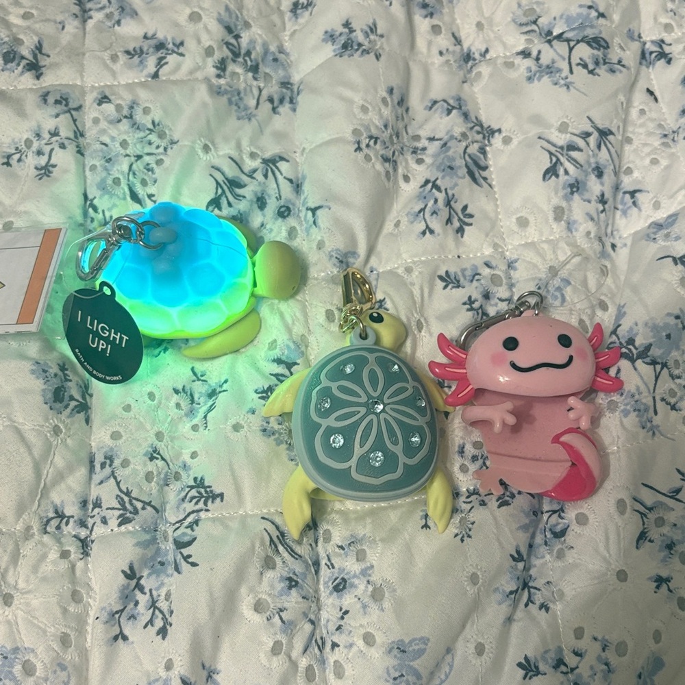 Bath & Body Works Light-Up Turtle and Pink Axolotl Sanitizer holder keychains